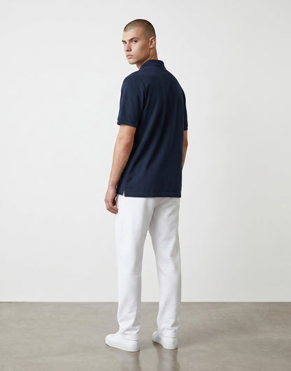 Home Kind navy blue 100% cotton polo shirt with a textured finish, structured collar, and button placket.